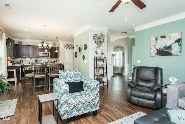 514 Alamanni Ct, Graham, NC 27253 - living room featuring arched walkways, dark wood-style floors, a ceiling fan, ornamental molding, and a chandelier
