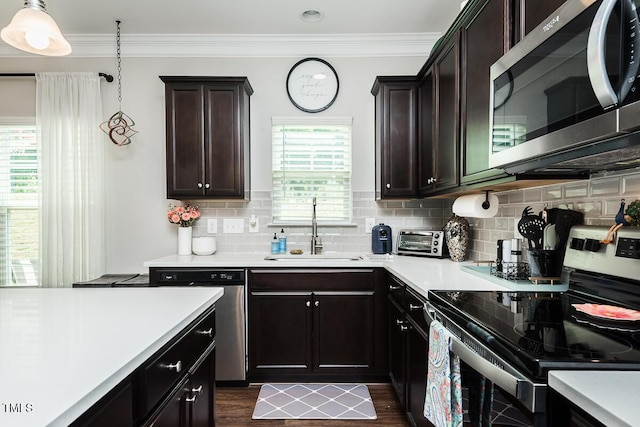 514 Alamanni Ct, Graham, NC 27253 - kitchen featuring appliances with stainless steel finishes, light countertops, ornamental molding, backsplash, and dark wood finished floors