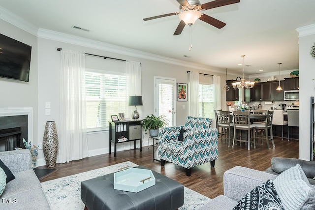 514 Alamanni Ct, Graham, NC 27253 - living area with a ceiling fan, crown molding, dark wood-style flooring, a chandelier, and a fireplace