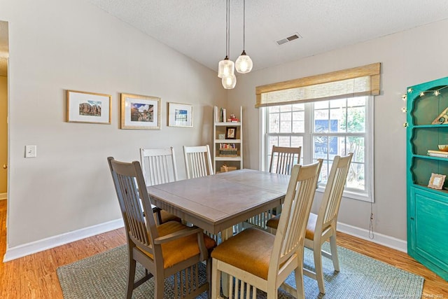 2 Beryl Cir, Pinehurst, NC 28374 - dining space featuring wood finished floors, a textured ceiling, and a chandelier