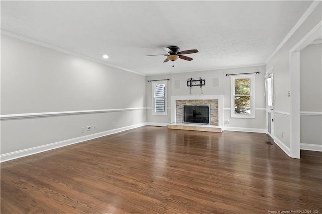 4304 Ferncreek Dr, Fayetteville, NC 28314 - unfurnished living room featuring plenty of natural light, crown molding, a ceiling fan, wood finished floors, and a stone fireplace