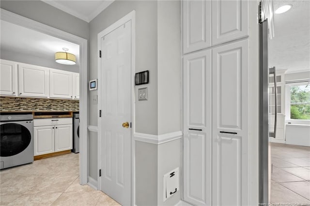 4304 Ferncreek Dr, Fayetteville, NC 28314 - washroom featuring cabinet space, washer / clothes dryer, crown molding, and light tile patterned flooring