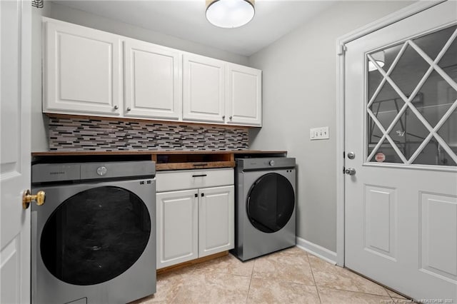 4304 Ferncreek Dr, Fayetteville, NC 28314 - laundry room featuring washer / clothes dryer, cabinet space, and light tile patterned flooring