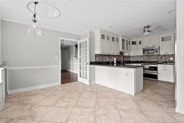 4304 Ferncreek Dr, Fayetteville, NC 28314 - kitchen featuring appliances with stainless steel finishes, dark countertops, decorative backsplash, a ceiling fan, and crown molding