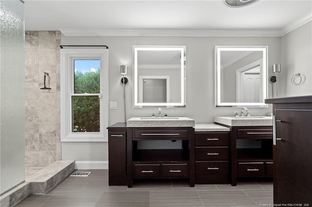4304 Ferncreek Dr, Fayetteville, NC 28314 - bathroom with two vanities, ornamental molding, a tile shower, and tile patterned flooring