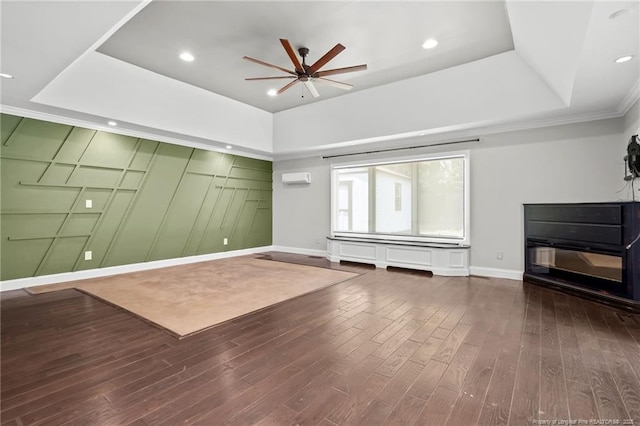 4304 Ferncreek Dr, Fayetteville, NC 28314 - unfurnished living room featuring a tray ceiling, a ceiling fan, wood finished floors, crown molding, and a wall mounted AC