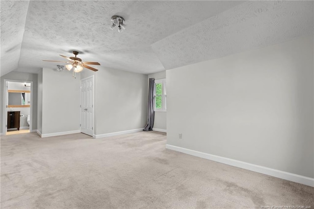 4304 Ferncreek Dr, Fayetteville, NC 28314 - empty room featuring a ceiling fan, light colored carpet, a textured ceiling, and lofted ceiling