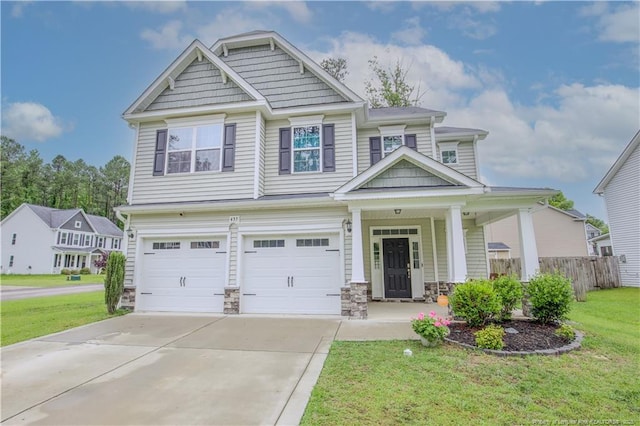 435 Lancaster Dr, Vass, NC 28394 - craftsman inspired home with an attached garage, driveway, a porch, and stone siding