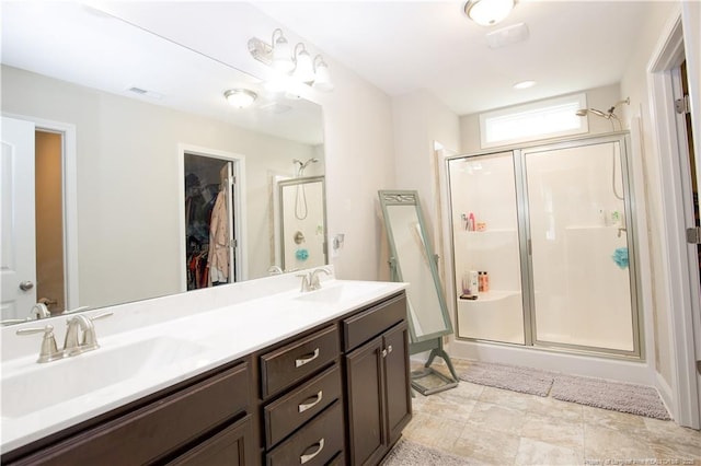 435 Lancaster Dr, Vass, NC 28394 - full bathroom featuring a stall shower, double vanity, and a spacious closet