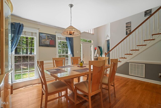 2401 Worthing Ct, Wake Forest, NC 27587 - dining space with light wood-type flooring, stairway, and crown molding