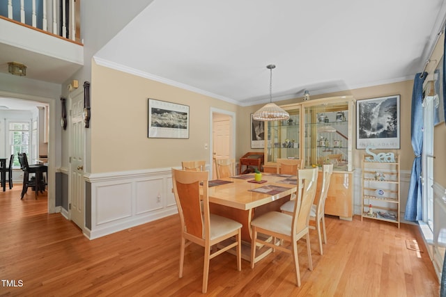 2401 Worthing Ct, Wake Forest, NC 27587 - dining space featuring light wood-style floors, ornamental molding, and a chandelier