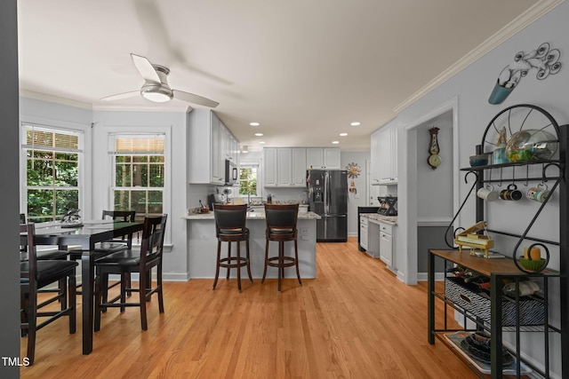 2401 Worthing Ct, Wake Forest, NC 27587 - dining room featuring ceiling fan, ornamental molding, light wood-style floors, and recessed lighting