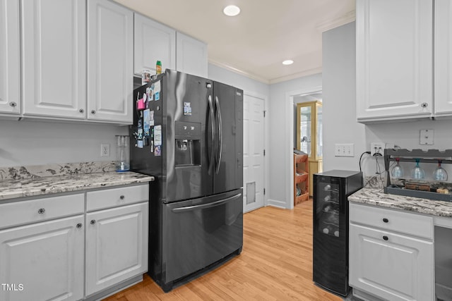 2401 Worthing Ct, Wake Forest, NC 27587 - kitchen featuring refrigerator with ice dispenser, white cabinets, light wood finished floors, ornamental molding, and light stone countertops