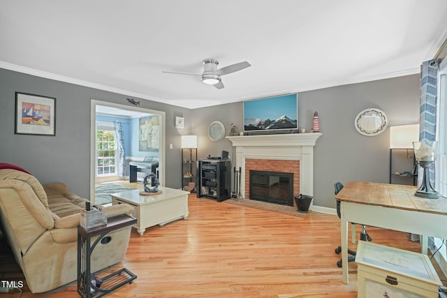2401 Worthing Ct, Wake Forest, NC 27587 - living area with ornamental molding, ceiling fan, wood finished floors, and a brick fireplace