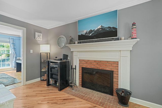 2401 Worthing Ct, Wake Forest, NC 27587 - living room with a brick fireplace, wood finished floors, and ornamental molding