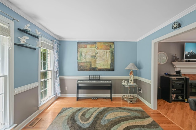 2401 Worthing Ct, Wake Forest, NC 27587 - sitting room with wood finished floors and crown molding