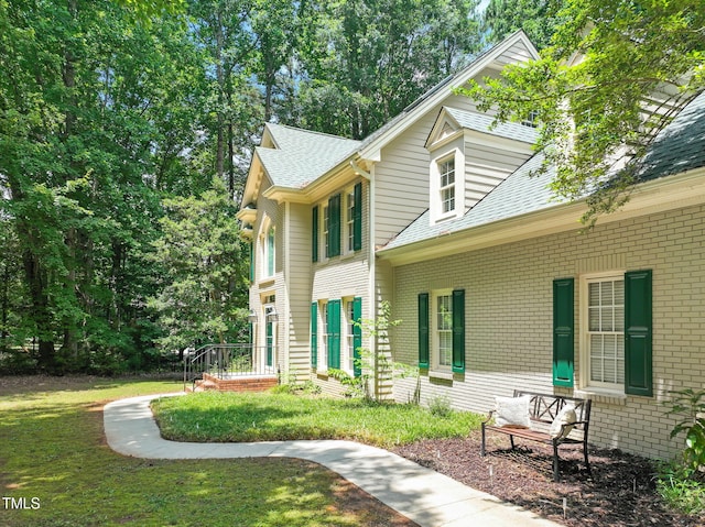 2401 Worthing Ct, Wake Forest, NC 27587 - view of property exterior with a yard, brick siding, and a shingled roof