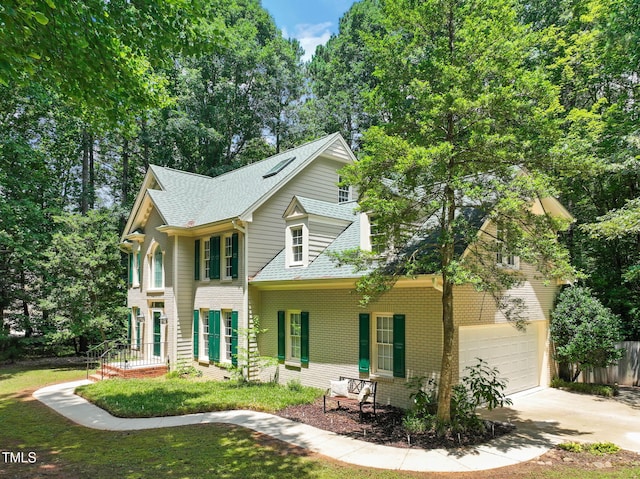 2401 Worthing Ct, Wake Forest, NC 27587 - view of front of home featuring driveway, a shingled roof, brick siding, and a garage