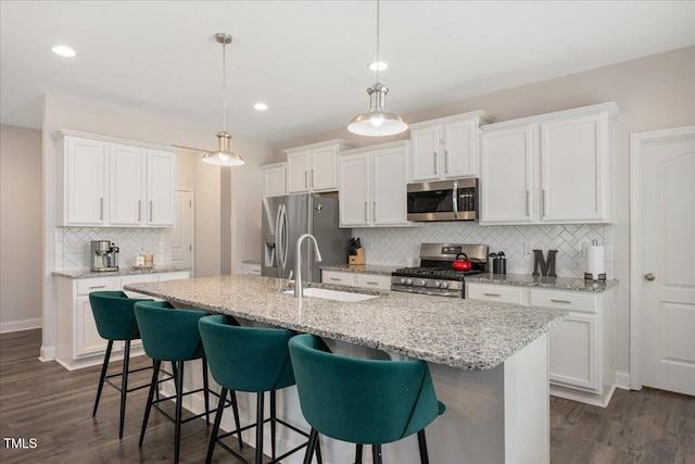 103 Foothill Ct, Sanford, NC 27330 - kitchen with stainless steel appliances, backsplash, white cabinetry, dark wood-style floors, and recessed lighting