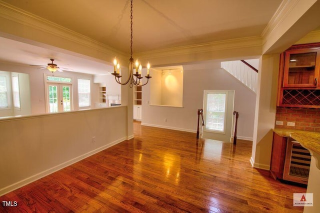 332 Bridgegate Dr, Cary, NC 27519 - unfurnished dining area featuring crown molding, wood finished floors, a chandelier, and stairway