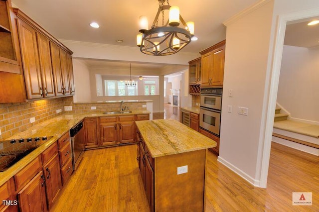 332 Bridgegate Dr, Cary, NC 27519 - kitchen featuring a chandelier, a peninsula, brown cabinets, appliances with stainless steel finishes, and light wood-style floors