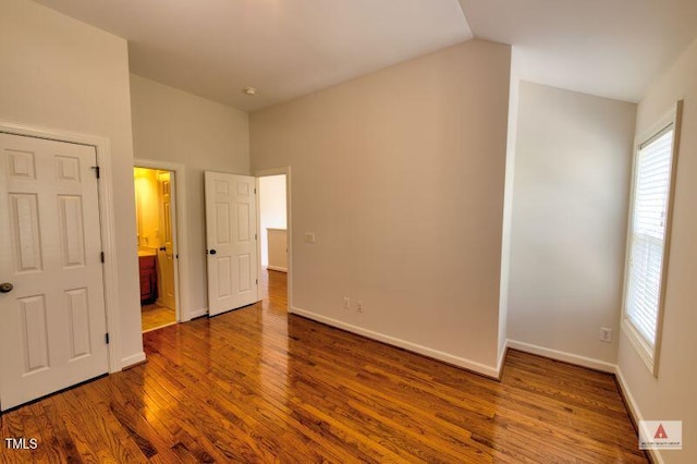 332 Bridgegate Dr, Cary, NC 27519 - unfurnished bedroom with wood finished floors, vaulted ceiling, and ensuite bathroom