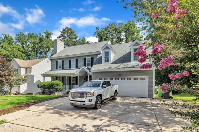 4309 Birmingham Way, Raleigh, NC 27604 - view of front facade with covered porch, driveway, and a chimney