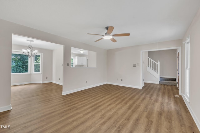 4309 Birmingham Way, Raleigh, NC 27604 - unfurnished room with a ceiling fan, wood finished floors, stairway, and a chandelier