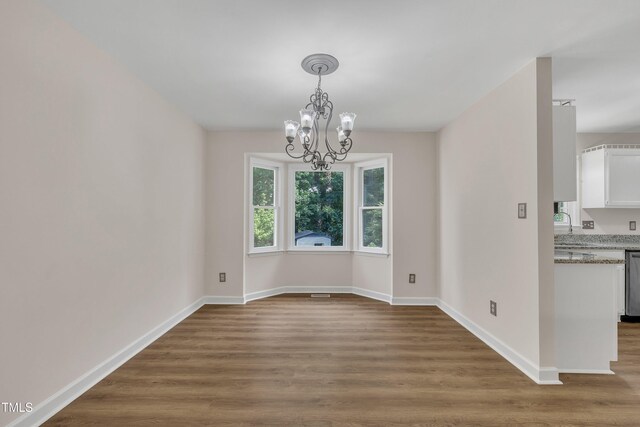 4309 Birmingham Way, Raleigh, NC 27604 - unfurnished dining area with a chandelier and wood finished floors