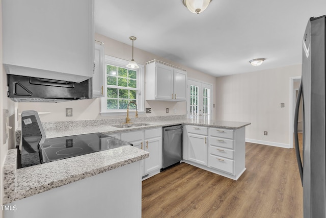 4309 Birmingham Way, Raleigh, NC 27604 - kitchen with appliances with stainless steel finishes, a peninsula, plenty of natural light, and white cabinets