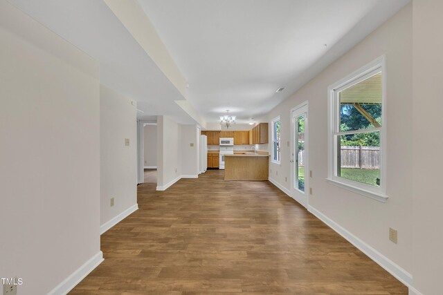4309 Birmingham Way, Raleigh, NC 27604 - unfurnished living room with a chandelier and dark wood-style floors