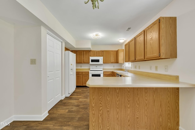 4309 Birmingham Way, Raleigh, NC 27604 - kitchen with white appliances, a peninsula, dark wood-type flooring, light countertops, and brown cabinetry