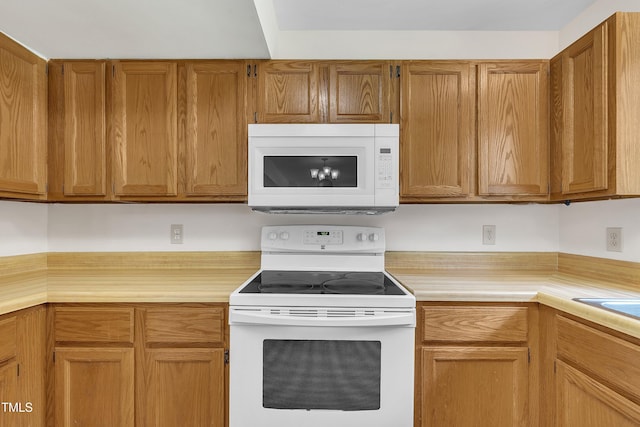 4309 Birmingham Way, Raleigh, NC 27604 - kitchen with white appliances, light countertops, and brown cabinetry