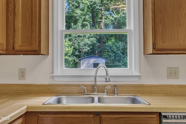 4309 Birmingham Way, Raleigh, NC 27604 - kitchen with light countertops, brown cabinetry, and plenty of natural light