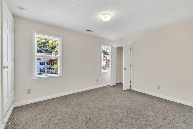 4309 Birmingham Way, Raleigh, NC 27604 - unfurnished bedroom featuring carpet and a textured ceiling