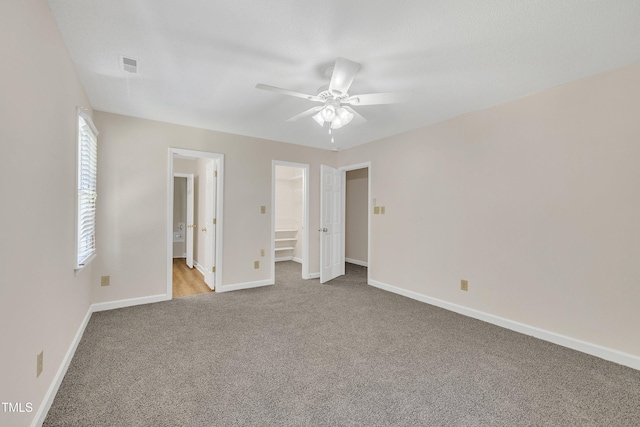 4309 Birmingham Way, Raleigh, NC 27604 - unfurnished bedroom with carpet floors, connected bathroom, a ceiling fan, and a walk in closet