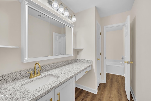 4309 Birmingham Way, Raleigh, NC 27604 - full bath with vanity, wood finished floors, and a garden tub
