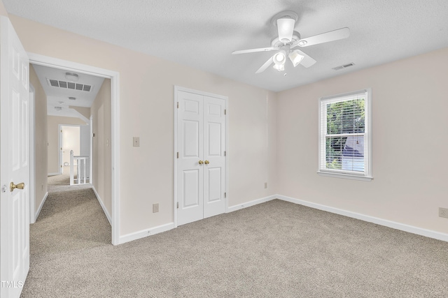 4309 Birmingham Way, Raleigh, NC 27604 - unfurnished bedroom with light carpet, a textured ceiling, a closet, and ceiling fan