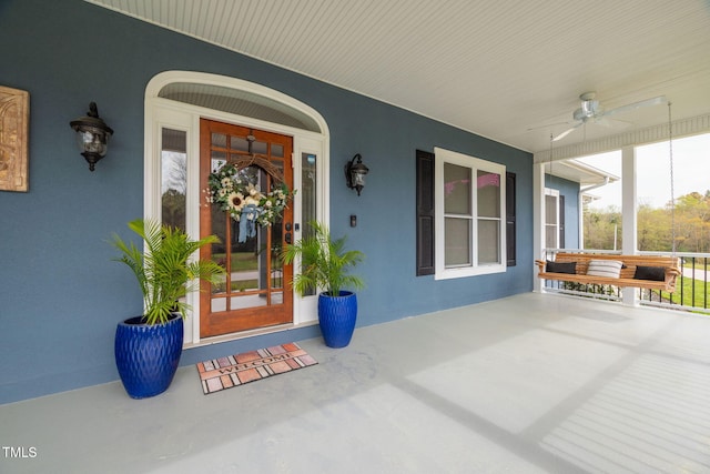 169 Skippers Lndg, Manson, NC 27553 - view of exterior entry with a porch, a ceiling fan, and stucco siding