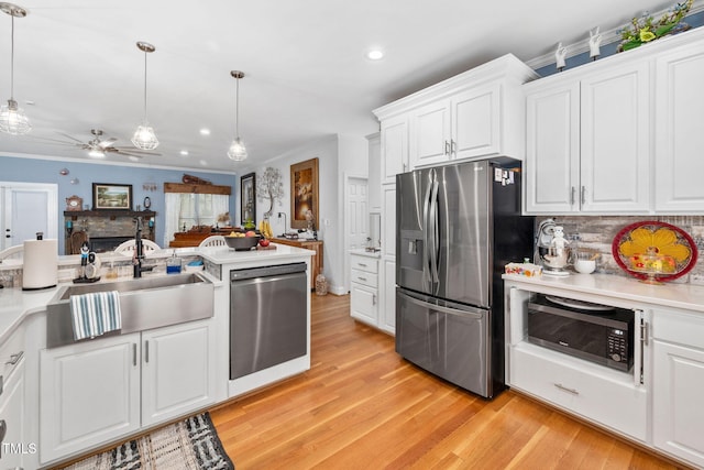 169 Skippers Lndg, Manson, NC 27553 - kitchen with stainless steel appliances, recessed lighting, light wood-style flooring, white cabinetry, and crown molding