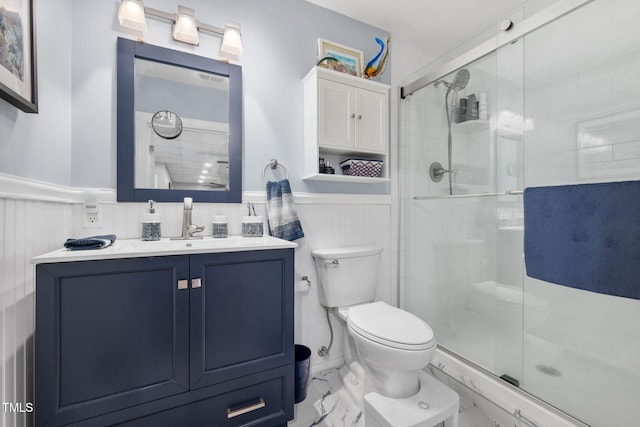 169 Skippers Lndg, Manson, NC 27553 - bathroom featuring wainscoting, marble look tile flooring, vanity, a shower stall, and a decorative wall