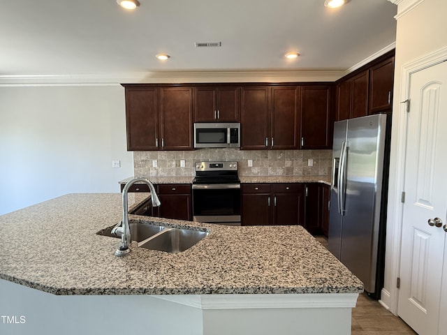 14 Gallop Rein Cir, Benson, NC 27504 - kitchen featuring stainless steel appliances, dark brown cabinetry, tasteful backsplash, light stone counters, and ornamental molding
