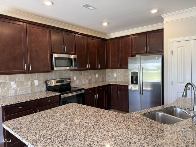 14 Gallop Rein Cir, Benson, NC 27504 - kitchen with stainless steel appliances, dark brown cabinets, light stone counters, decorative backsplash, and crown molding