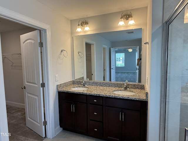 14 Gallop Rein Cir, Benson, NC 27504 - full bathroom featuring double vanity, a walk in closet, and tile patterned flooring