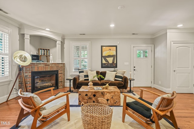 211 W Trinity Ave, Durham, NC 27701 - living room featuring wood finished floors, ornamental molding, a fireplace, recessed lighting, and ornate columns