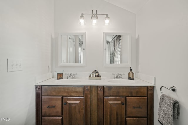 211 W Trinity Ave, Durham, NC 27701 - bathroom featuring double vanity and vaulted ceiling