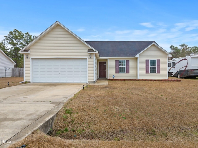 205 Driftwood Ln, Raeford, NC 28376 - ranch-style home featuring an attached garage, concrete driveway, a front lawn, and roof with shingles