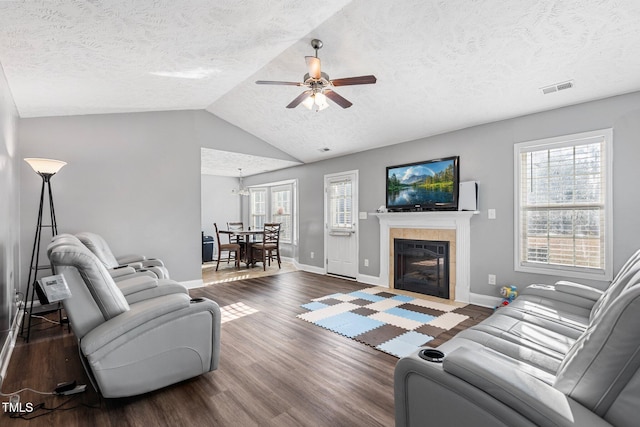 205 Driftwood Ln, Raeford, NC 28376 - living room with a ceiling fan, a textured ceiling, wood finished floors, a tiled fireplace, and lofted ceiling