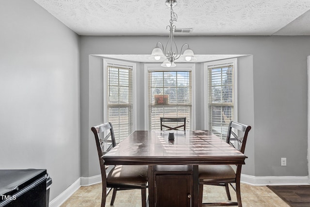 205 Driftwood Ln, Raeford, NC 28376 - dining space featuring a chandelier and a textured ceiling