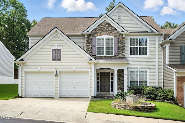 5421 Brandy Bay Rd, Raleigh, NC 27613 - traditional home with concrete driveway, a garage, a front lawn, stone siding, and a shingled roof